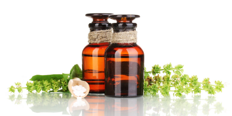 Amber apothecary bottles and herbs representing compounded and natural health products